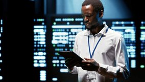 African American IT programmer supports AI computing in a data center, connecting artificial intelligence, machine learning workloads and large scale data processing during server diagnostics. - Powered by Shutterstock - Get 15% off with code: PIKWIZARD15