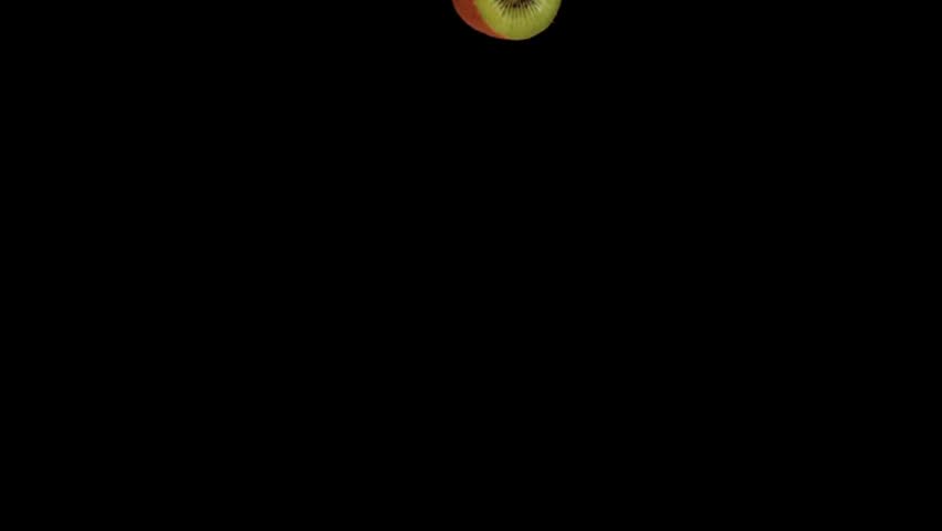 Halved fresh kiwi fruits falling through the air against a solid black background. Ideal for juice commercials, fruit montages, and dynamic food presentations
