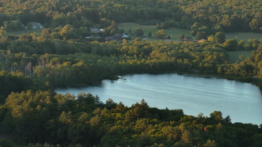 Aerial view of a lake in rural Connecticut. Shot on a summer day at sunset.