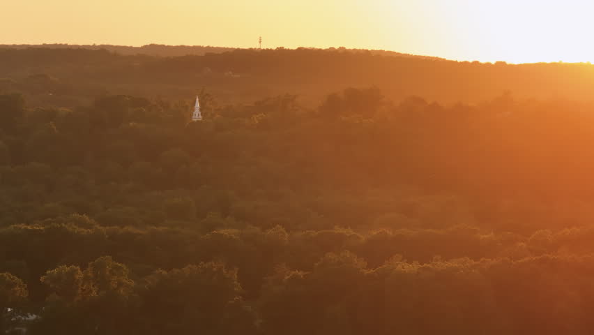 Aerial view of rolling hills and forest in rural Connecticut. Shot at sunset during the summer,