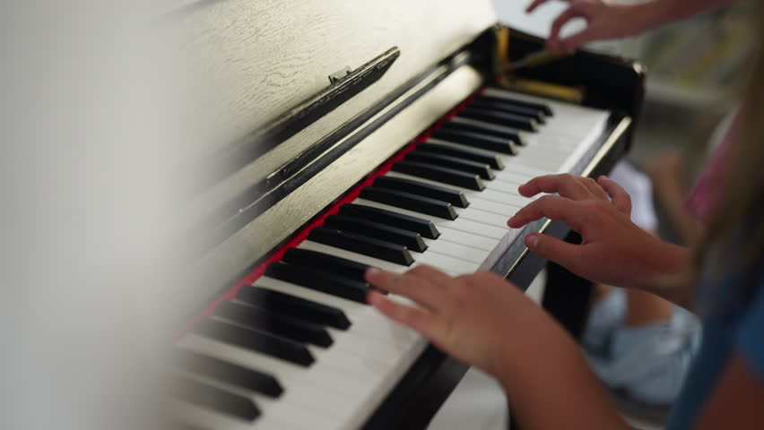 Young girl practicing piano in classroom developing music skills creativity concentration confidence through school music education performing arts training and childhood learning