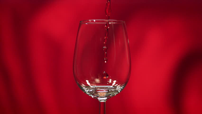 Ultra Slow Motion Red Wine Pouring Into Tilted Glass