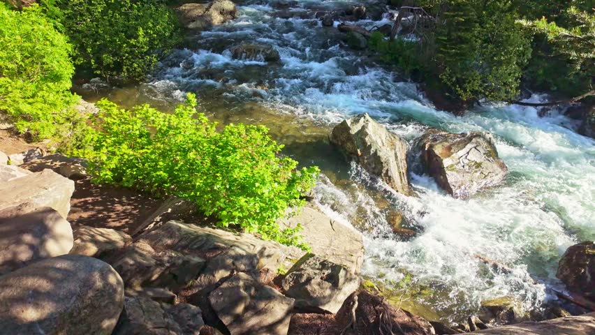Scenic waterfall on Cascade Creek surrounded by lush forest near Jenny Lake in Grand Teton National Park