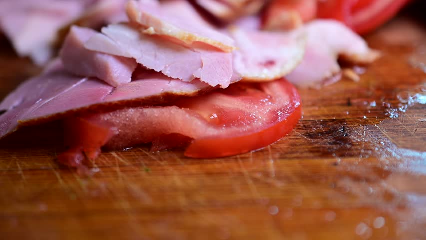 slicing ham cold cut meats cut tomato macro food background video