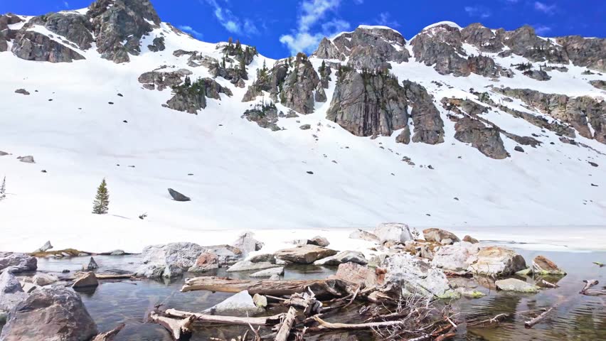 Pristine alpine Lake Solitude surrounded by towering Teton peaks in a sweeping panoramic view