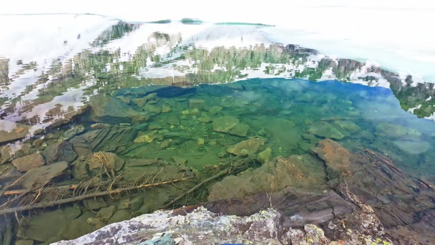 Pristine alpine Lake Solitude surrounded by towering Teton peaks in a sweeping panoramic view