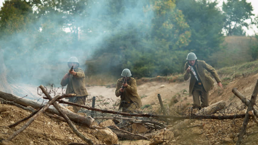 Historical military reenactment showing soldiers in a defensive trench position in ultra slow motion