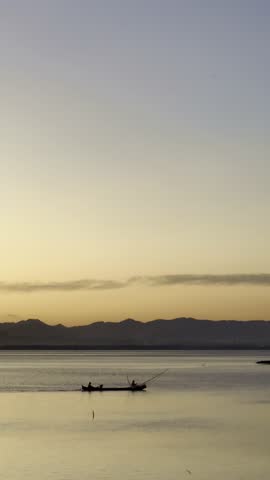 Two Fishermen in Boat at Sunrise
