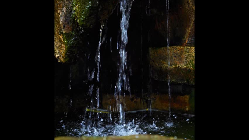 Artificial Waterfall Over Mossy Rocks.
A close-up shot of a small artificial waterfall cascading over moss-covered stones into a calm garden pond. Ideal for concepts of nature, tranquility, and Zen.