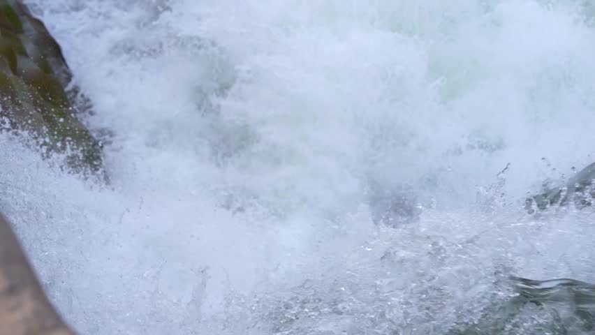 Rushing River Water Flowing Swiftly Over Rocks in a Natural Stream