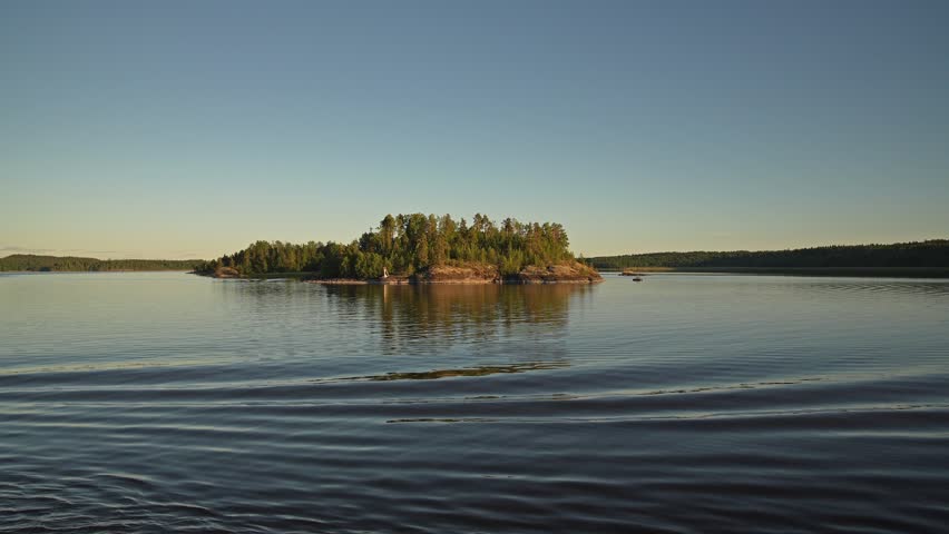 Small island in the northern lake at sunset