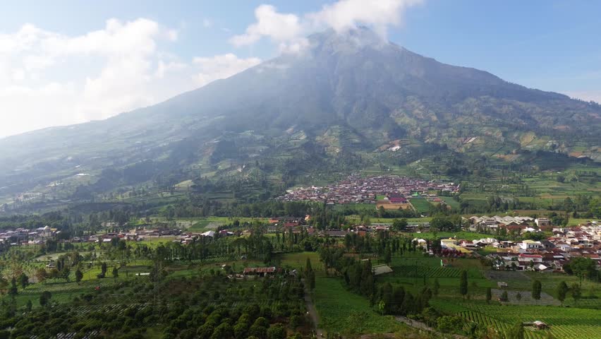 Aerial drone footage showcasing the majestic landscape of Mount Sumbing, an active stratovolcano and the second-highest volcano in Central Java, Indonesia.