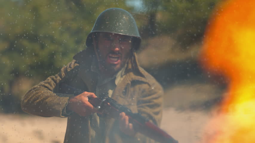 Historical reenactment featuring a soldier aiming and firing rifle as sparks and blast flare in battlefield training scene.