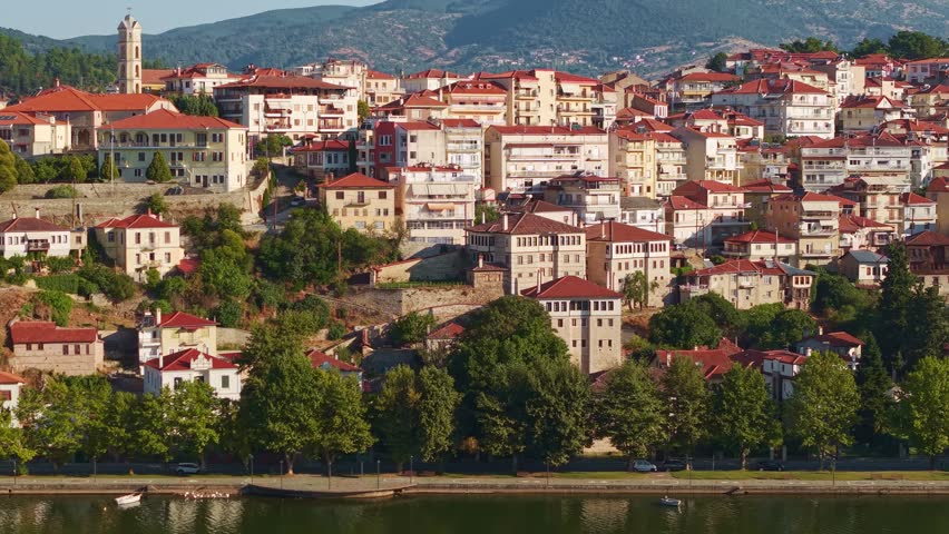 High angle view of the traditional houses and red roofs of Kastoria city during a hazy morning by the lake in Greece
