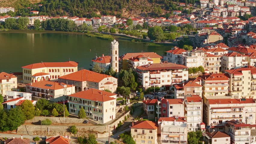 High angle view of the traditional houses and red roofs of Kastoria city during a hazy morning by the lake in Greece