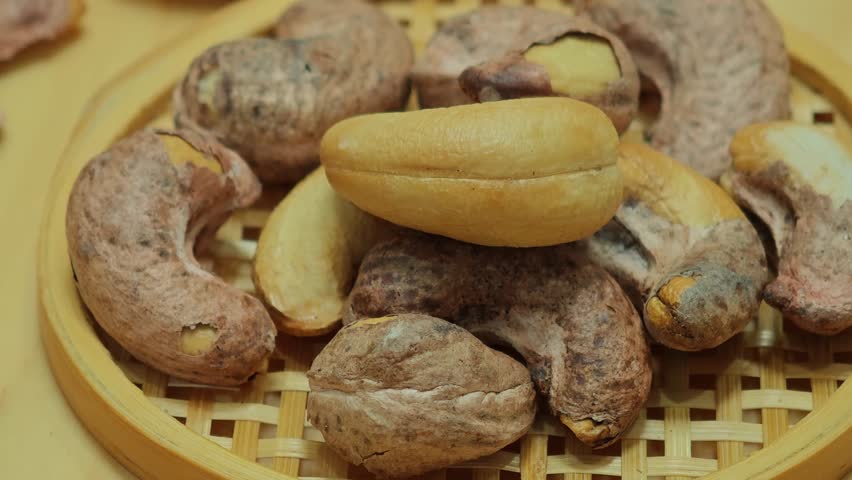 Cashew nuts on a bamboo tray.