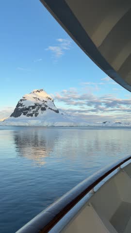 Antarctica Point of View From Cruise Ship Pan Across Boat to Epic Sunset, Calm Glassy Water to Glaciers Mountains Snow and Ice (Vertical Video)