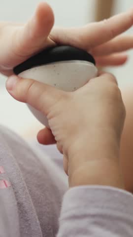 Vertical video. Child shapes a plasticine dinosaur with a mold during creative play at home.