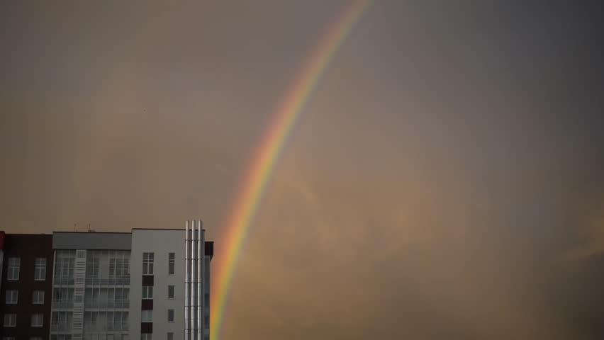 Rainbow over city buildings after rain