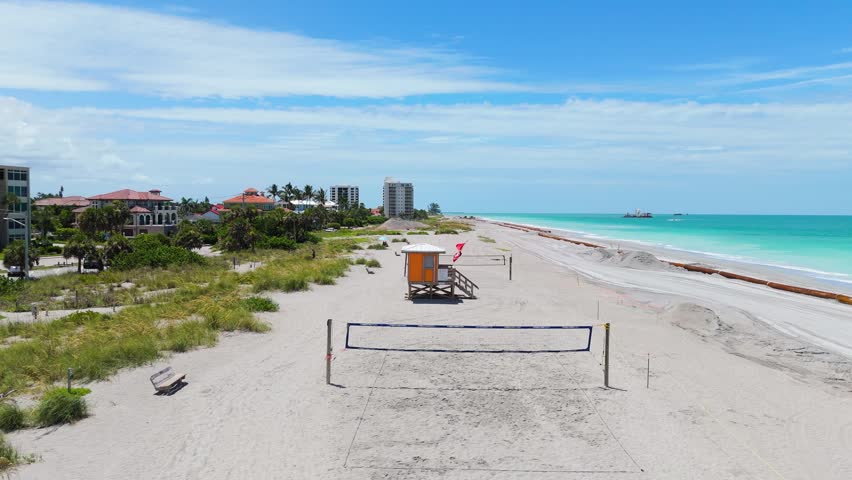Drone View Of Venice Beach Florida With Volleyball Nets Lifeguard Tower And Waves