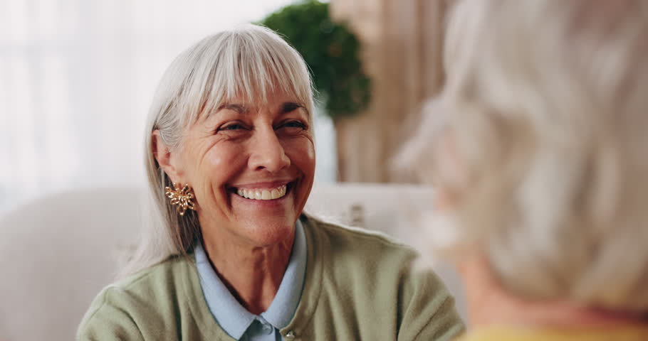 Smile, old woman and friends in home with hug, welcome and bonding together for reunion. Happy, senior people and gratitude in lounge with embrace, friendly affection and compassion for weekend visit