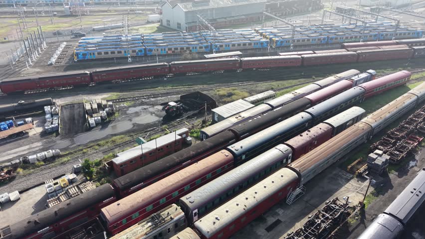 Aerial perspective of an old abandoned railway station depot with rusty trains parked on the tracks