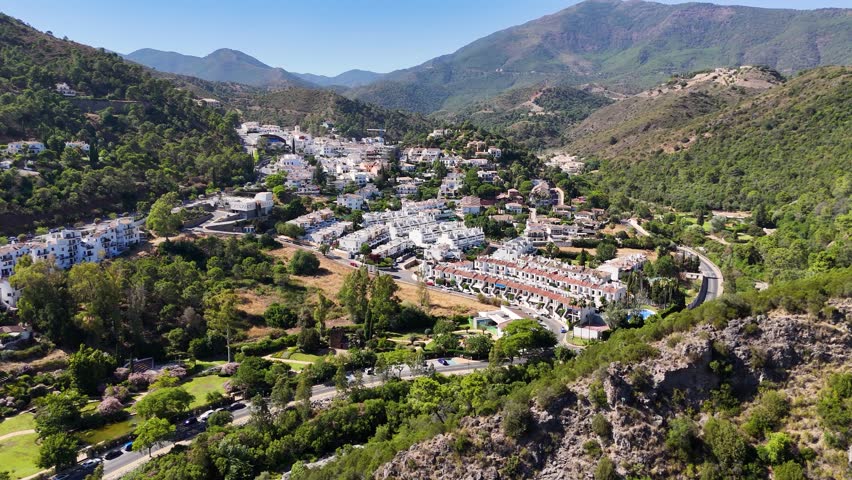 Aerial view of white village of Benahavis in mountain valley, Spain