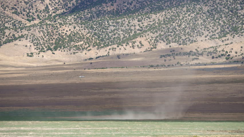 Dirt devil moving in slow motion through the Utah desert during extreme drought season.