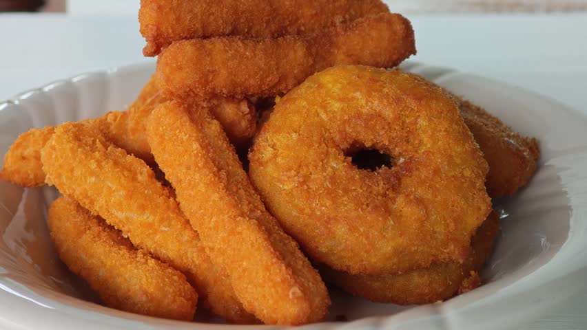 Deep-fried shrimp in batter, served on a plate.