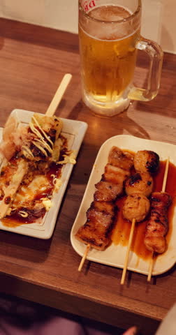 Woman, hands and pointing with chicken skewer in restaurant above for food or cuisine. Top view, female person or poultry sticks with recipe, snack or sauce for kebab, Yakitori or eating in diner