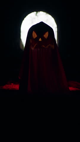 Vertical video. Ghost Shaped Jack O Lantern Silhouette in Dark Tunnel Against Bright Exit Light, Halloween Mystery, Horror Mood And Dramatic Contrast.