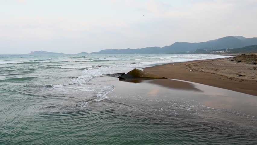 Beautiful beach in Jinshan District, wave splashed on the sands, in New Taipei City, Taiwan.