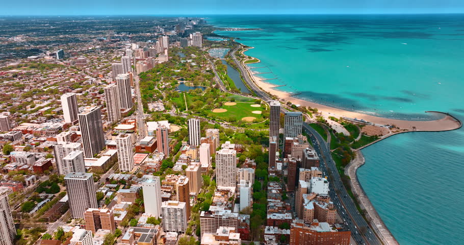 Spectacular view of green park surrounded by high-rises at the waterfront of Lake Michigan. Aerial perspective on the stunning Lakeshore Drive in Chicago, Illinois, USA.
