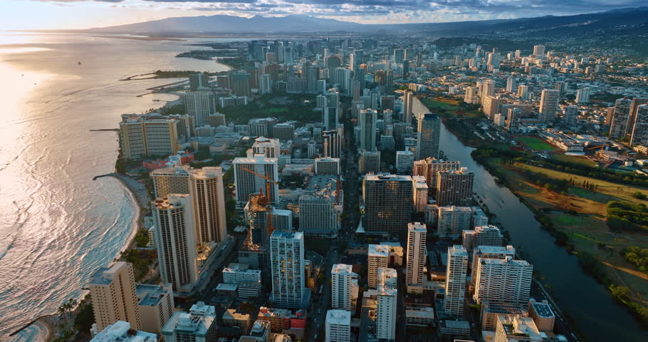 Going up over the scenery of luxurious Waikiki at sunset. Aerial perspective on Honolulu, Oahu, Hawaii, USA.