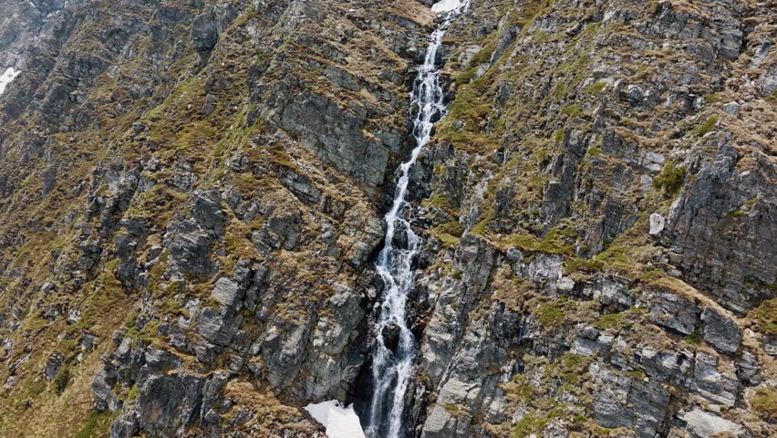 Skakavitsa waterfall or Rila mountain cascade flowing down steep rocky cliffs aerial drone view rushing fresh water stream wilderness hiking destination summer travel Rila national park Bulgaria scenery.