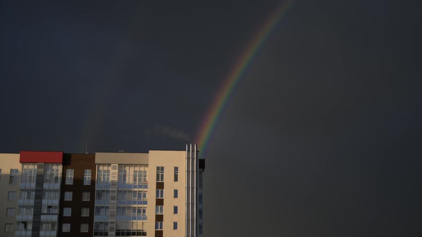Rainbow over city buildings after rain