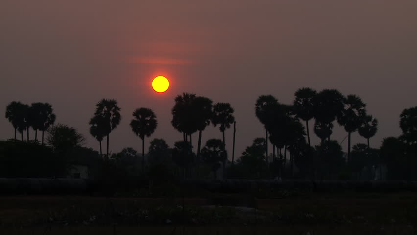 Time lapse of hot air balloon rising over sunrise in Cambodia