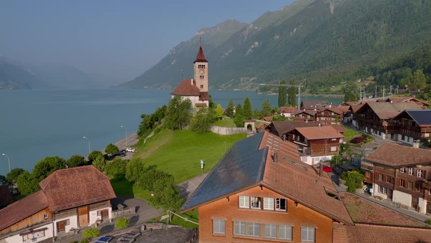 Solar Panel Roof on the Building in Swiss town surrounded my Alps Mountains. Renewable Energy in Brienz, Switzerland