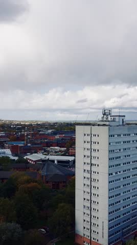 BIRMINGHAM, UK Scenic high-angle cityscape panoramic view of Birmingham city under a dramatic cloudy sky featuring a vibrant colorful rainbow after the rain.