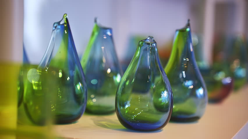 Close up shot of handmade glass souvenir decorations shaped like teardrops displayed on a table at a local craft shop in the Lofoten islands, Norway