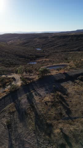 Aerial vertical view over rocky semi desert terrain dotted with small ponds in the arid countryside, Aguascalientes, Mexico