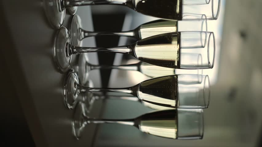 Champagne glasses lined up, close-up. Close-up of multiple glasses of sparkling wine.