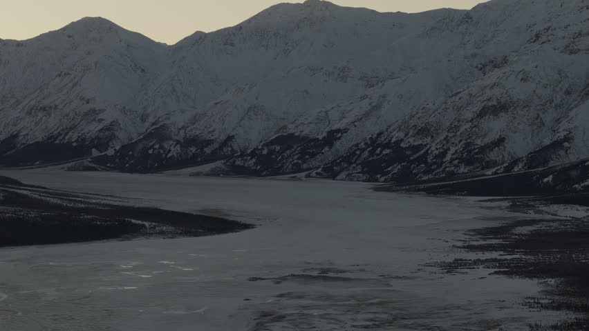 Golden Light On Snow Mountains Near Silver City, Yukon Canada. Wide Shot