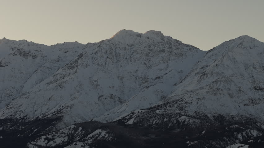 Sunset Glow On Snowcapped Mountains Near Silver City, Yukon Canada. Wide Shot