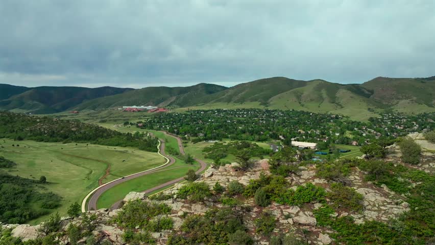 Ken Caryl Valley Ranch Hogback Ridge summer sunny morning blue sky Meadow Ranch South Valley trail entrance Denver Colorado aerial drone Front Range Rocky Mountains foothills forward pan up