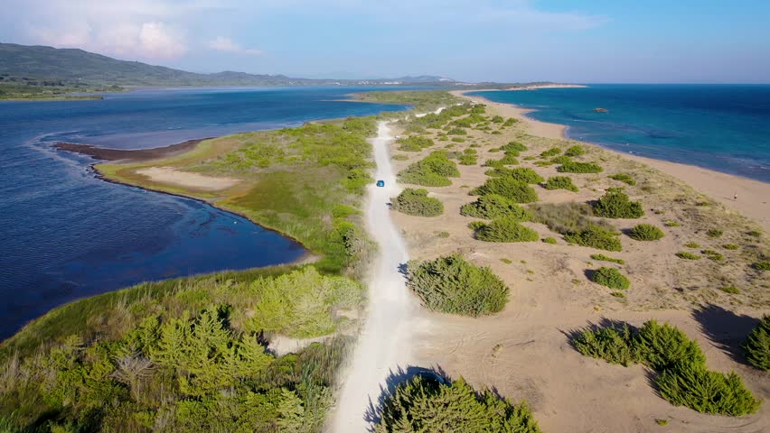 Road on a land strip between Korission Lake coastal lagoon and Ionian Sea on Corfu Island, Greece, 4k video