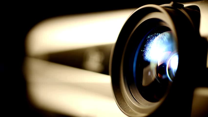 Detailed close-up of camera lens demonstrating light reflection and intricate design, capturing the essence of photography and videography gear.