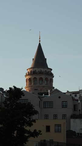 Cinematic video footage of the historic Galata Tower in Istanbul, Türkiye. The medieval stone tower stands as one of Istanbul