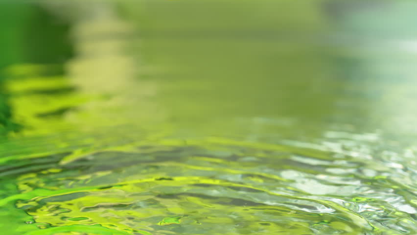 Super Slow Motion Shot of Fresh Orange Fruit Falling into Water and Making Splash at 1000fps.