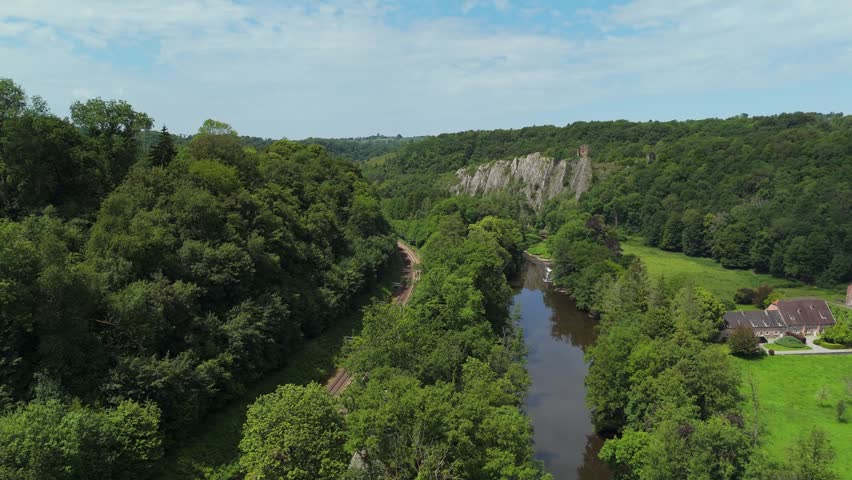 Railway Tracks Passing Beneath Forest Cliffs in Belgium
